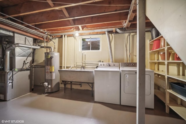 basement featuring sink, separate washer and dryer, heating unit, and water heater