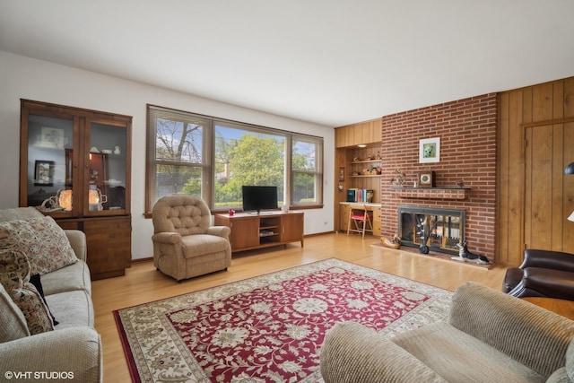 living room featuring a fireplace and light hardwood / wood-style flooring