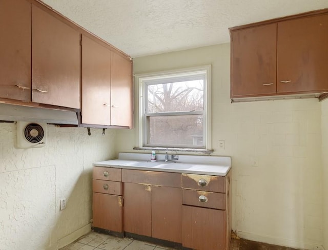 kitchen with a textured ceiling and sink