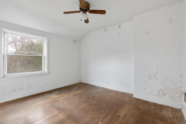 empty room featuring vaulted ceiling, ceiling fan, and dark hardwood / wood-style floors