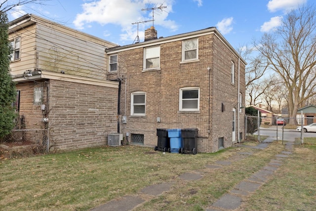 rear view of house featuring a yard