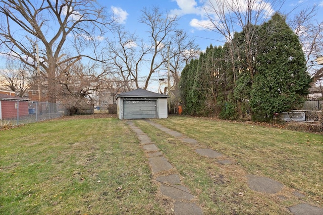 view of yard featuring a garage and an outdoor structure