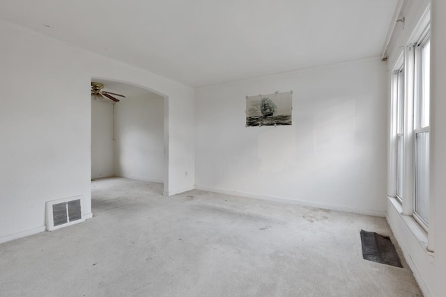 unfurnished room with ceiling fan and light colored carpet