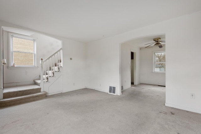 spare room featuring light carpet and ceiling fan