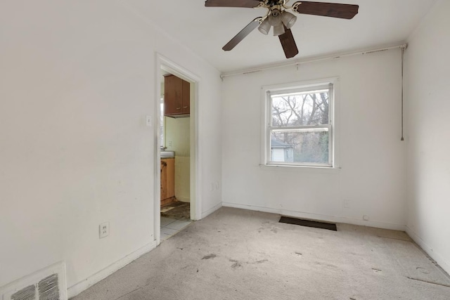 carpeted empty room with ceiling fan