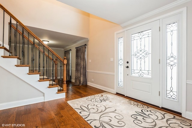 entryway featuring dark hardwood / wood-style flooring and ornamental molding