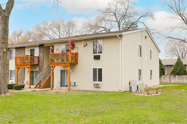 rear view of house with a yard and a deck