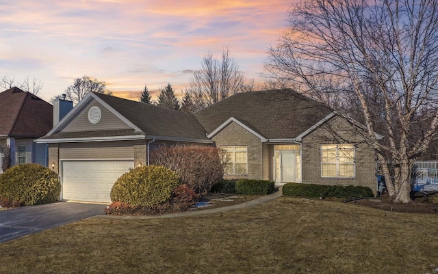 view of front of home featuring a lawn and a garage