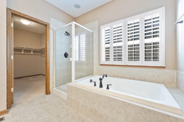 bathroom with tile patterned floors and separate shower and tub