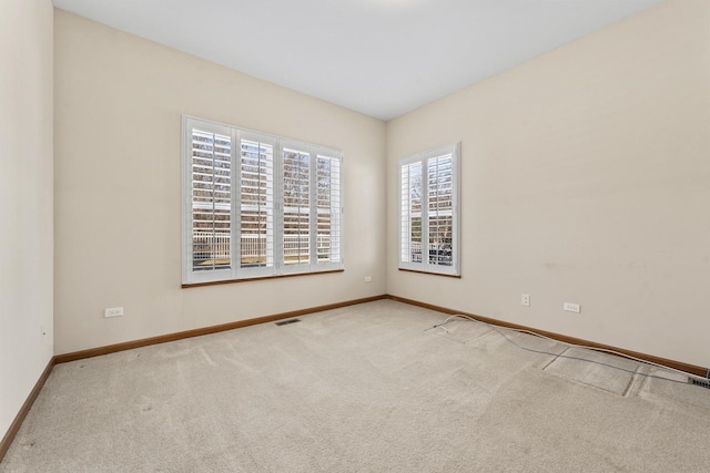 unfurnished room with light carpet