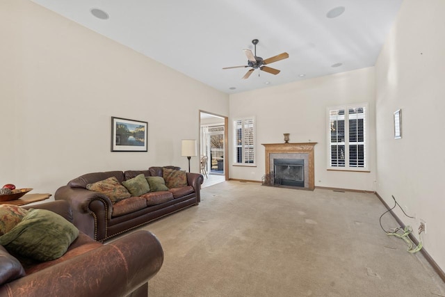 carpeted living room featuring ceiling fan