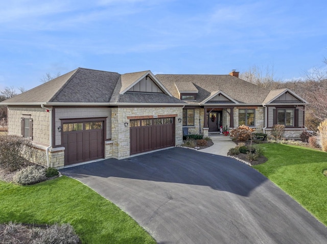 craftsman house with a garage and a front lawn