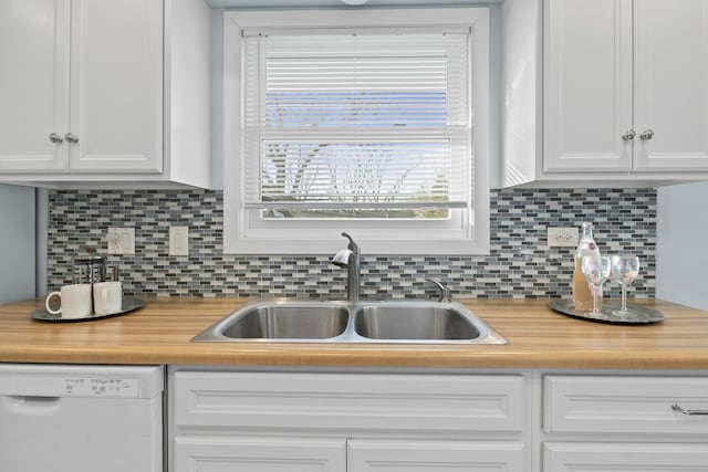 kitchen featuring backsplash, white dishwasher, sink, and white cabinets