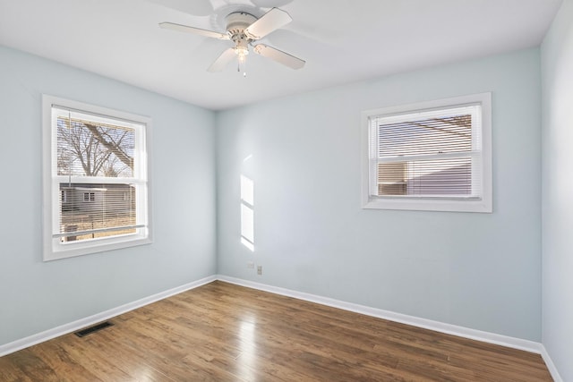 empty room featuring hardwood / wood-style flooring and ceiling fan