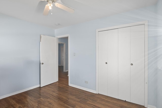 unfurnished bedroom featuring dark hardwood / wood-style flooring, a closet, and ceiling fan