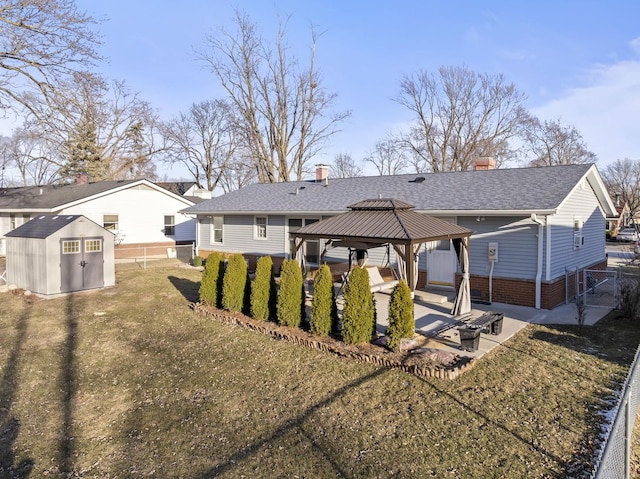 back of property with a gazebo, a yard, a patio area, and a shed