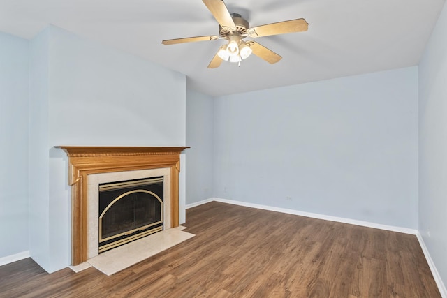 unfurnished living room with dark hardwood / wood-style floors and ceiling fan