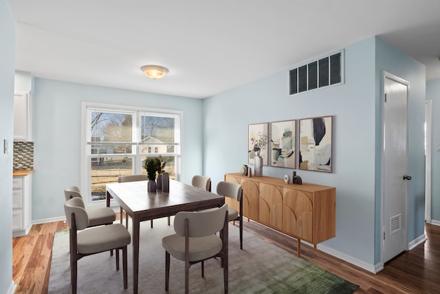 dining space featuring hardwood / wood-style flooring