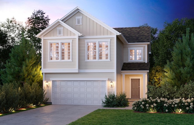 view of front of property featuring a lawn and a garage