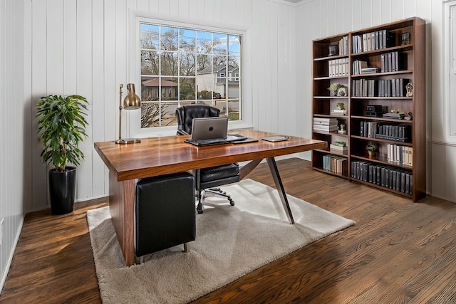 office area featuring wood walls and dark wood-type flooring