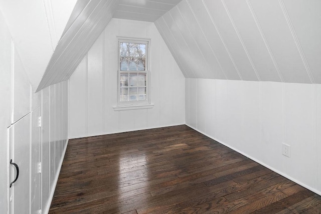 additional living space with lofted ceiling and dark wood-style flooring