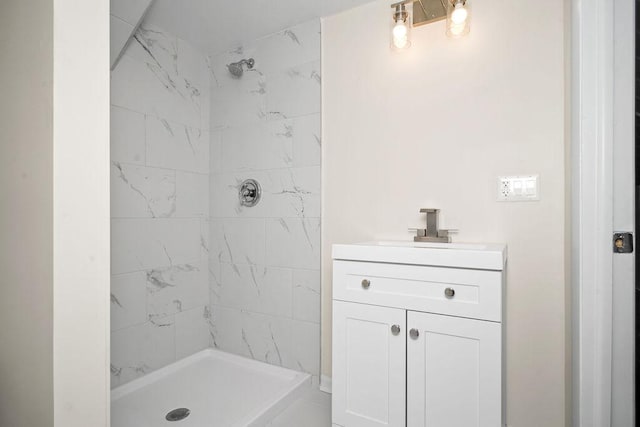 bathroom featuring a shower stall and vanity