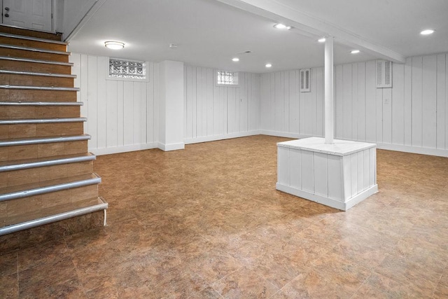 finished basement featuring recessed lighting, visible vents, stairway, baseboards, and tile patterned floors