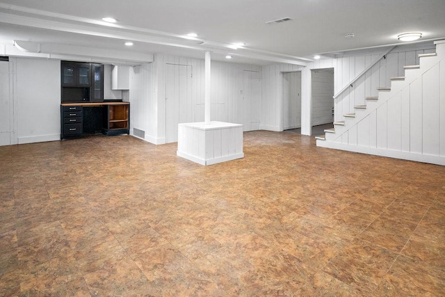 finished basement featuring baseboards, stairway, visible vents, and recessed lighting