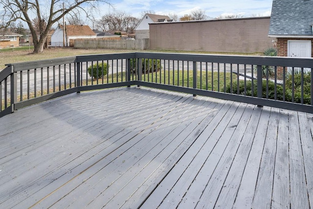 wooden terrace with a lawn