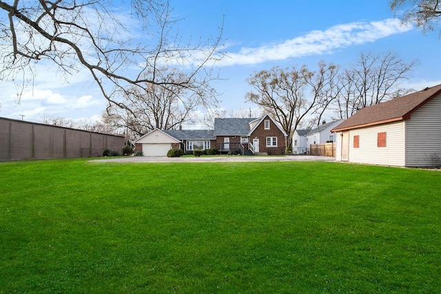 view of yard with fence and a detached garage