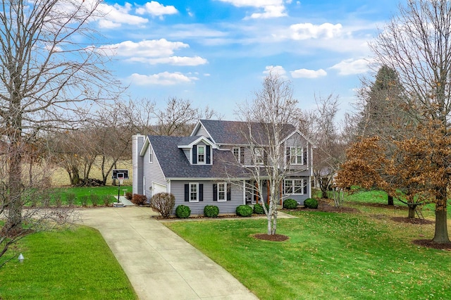 view of front of house with driveway, a garage, roof with shingles, and a front lawn