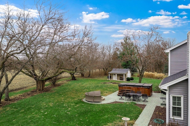 view of yard with a patio, an outbuilding, an outdoor fire pit, and a hot tub