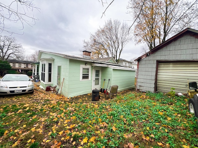 rear view of property featuring a garage