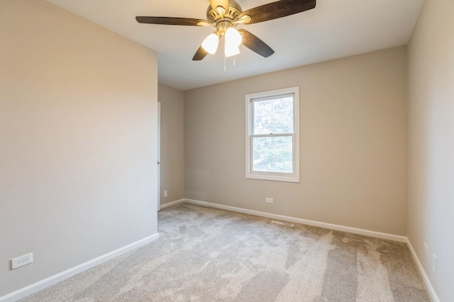 unfurnished room featuring ceiling fan and light colored carpet