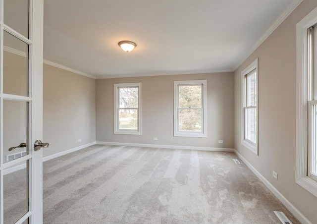 empty room with ornamental molding, light carpet, and french doors