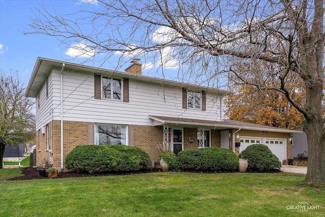 view of property featuring a garage and a front lawn