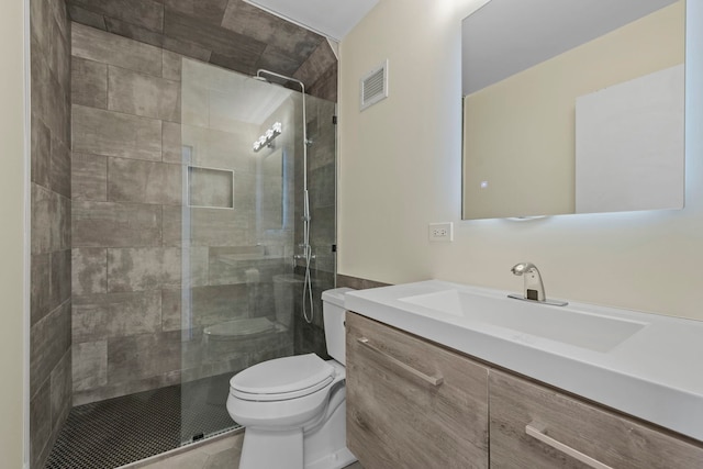 bathroom featuring a shower with door, tile patterned floors, vanity, and toilet