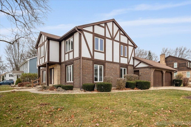 view of side of property featuring a garage and a lawn