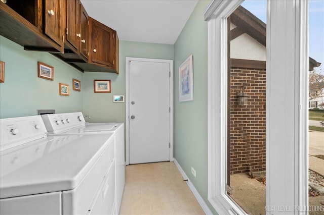 laundry area featuring cabinets and washing machine and clothes dryer