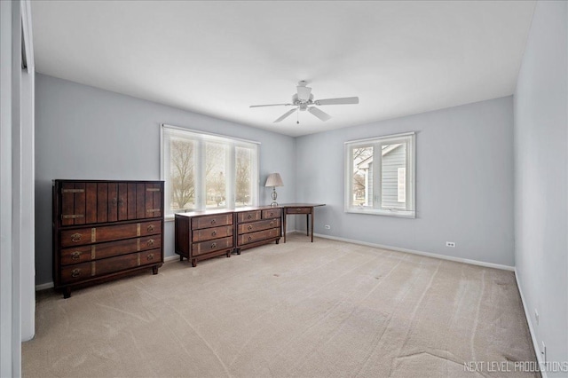 bedroom with multiple windows, light colored carpet, and ceiling fan