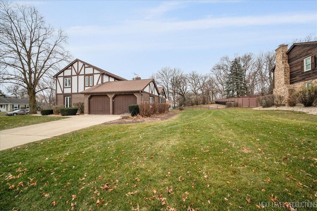 view of side of home featuring a yard and a garage