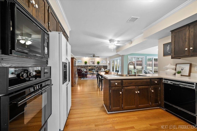 kitchen featuring sink, ceiling fan, dark brown cabinets, black appliances, and kitchen peninsula