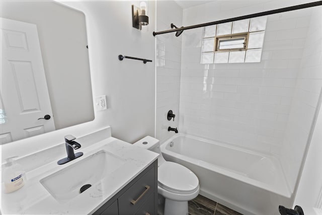 full bathroom with toilet, wood-type flooring, vanity, and tiled shower / bath combo