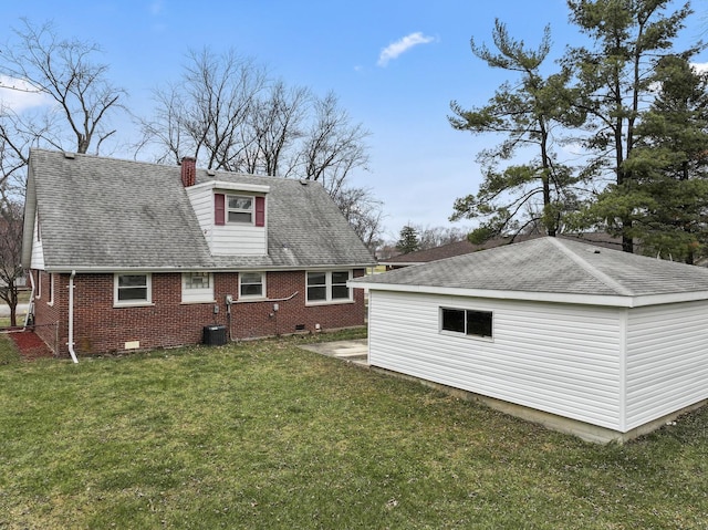 rear view of house featuring a lawn and cooling unit