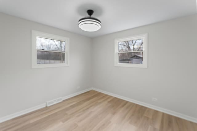 unfurnished room featuring light wood-type flooring and a wealth of natural light