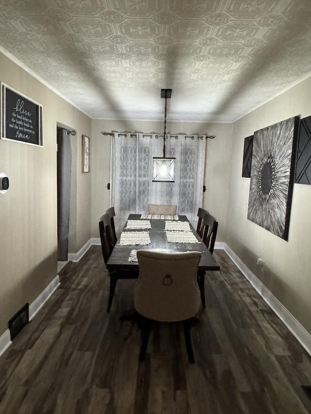 unfurnished dining area with a textured ceiling, wood finished floors, and baseboards