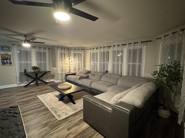 living area with ceiling fan, baseboards, and wood finished floors