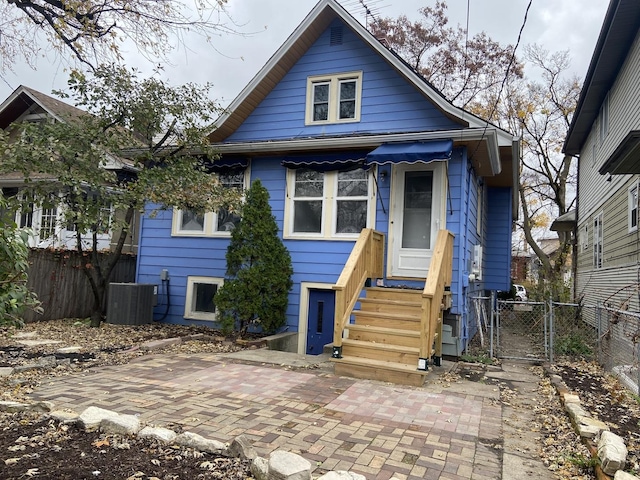 view of front of home with a patio and central air condition unit