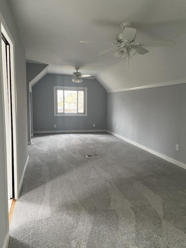 bonus room with lofted ceiling, ceiling fan, and carpet floors