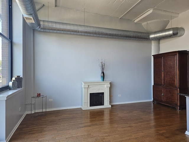 unfurnished living room featuring dark hardwood / wood-style floors